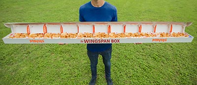Man holding open wingspan box